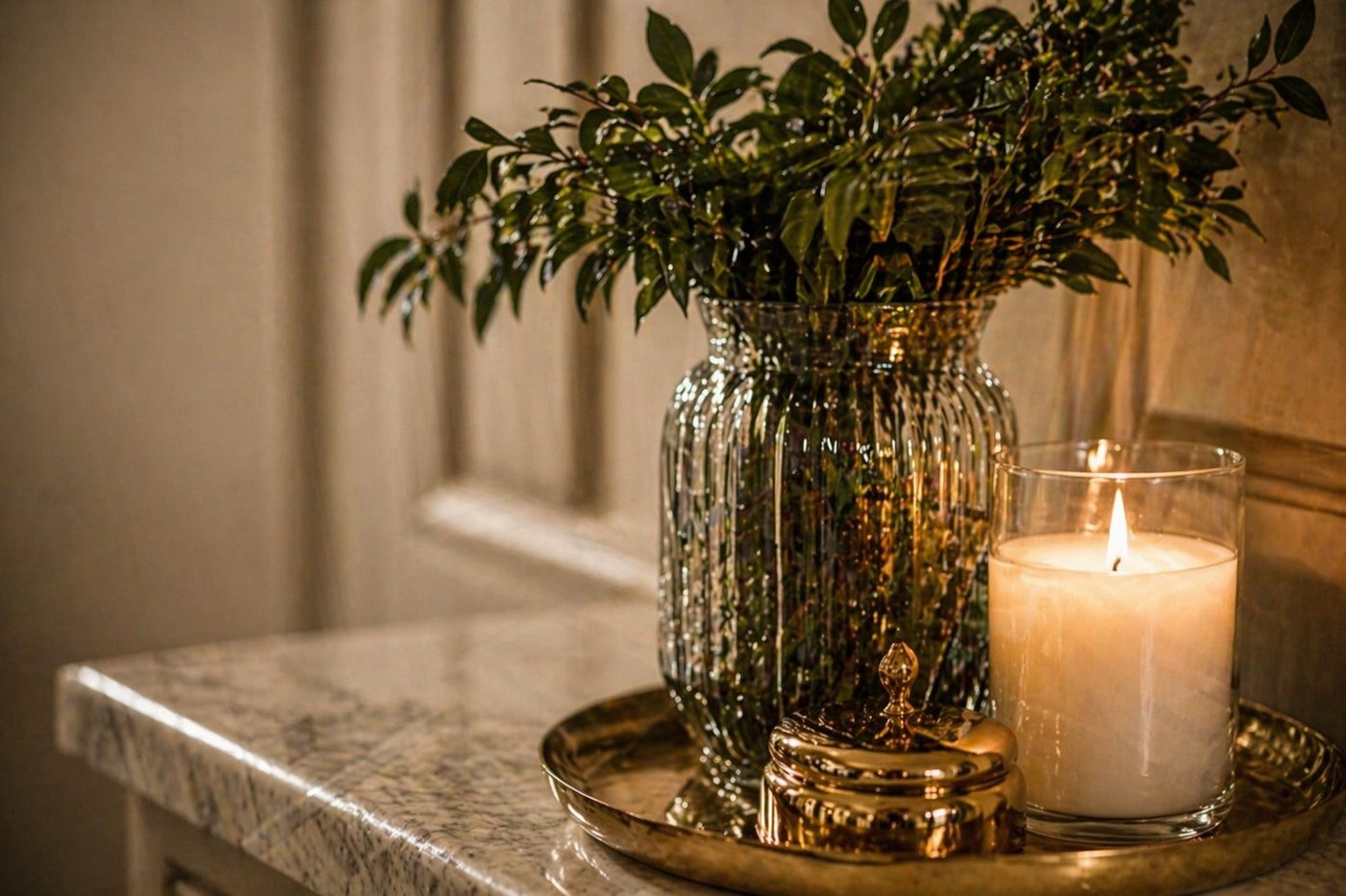 Candle and greenery vignette at golden hour